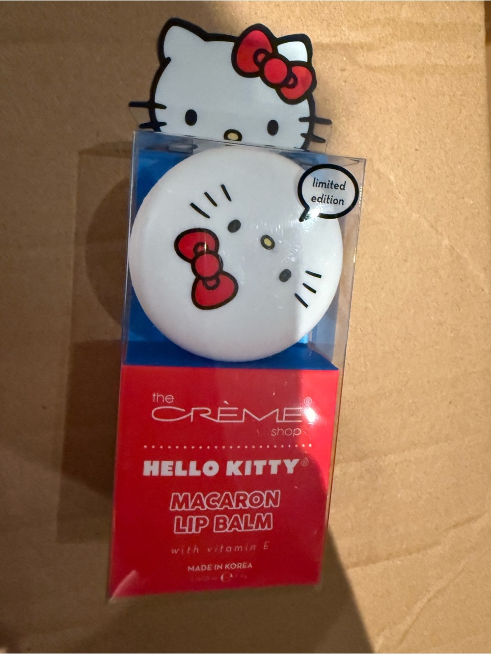 The Crème Shop Hello Kitty Macaron Lip Balm - White with Red Bow